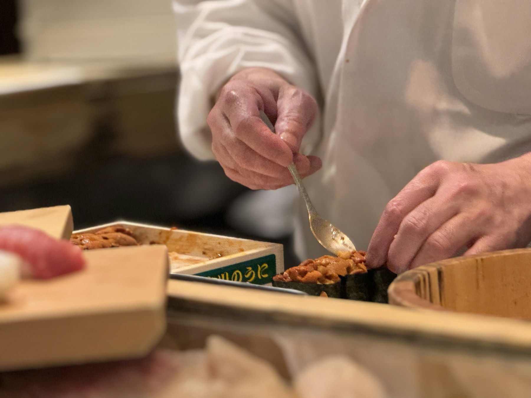 A sushi chef at work behind the counter